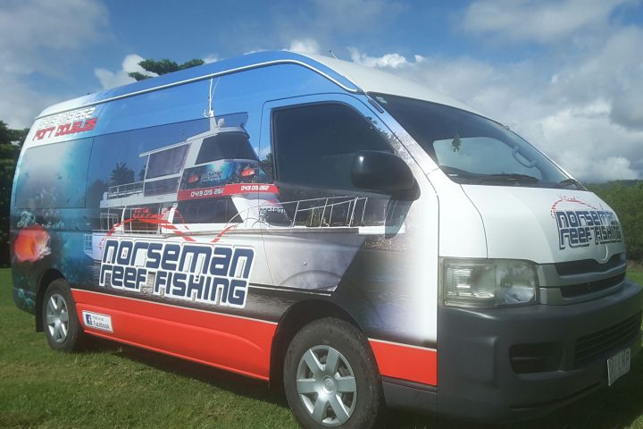 a van is parked on a patch of grass